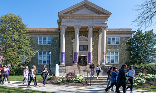 Students walking infront of the old library building