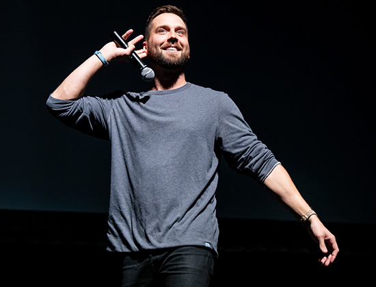 Trey Kennedy On stage performing comedy