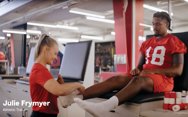 Kansas City Chiefs Assistant Athletic Trainer Julie Frymyer ’05 is starring in a StateFarm commercial alongside famed quarterback Patrick Mahomes and singer Meghan Trainor. The advertisement features a clever twist on who the real trainer is — Julie or the pop star — and has quickly become a favorite among Golden Rams.