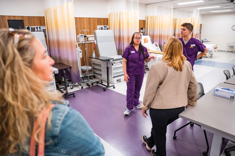During the anniversary celebration of the nursing programs’ 50+ years, WCU nursing students (L-R) Christina Ngo and Adam Hudson shared details about the state-of-the-art Immersive Learning Center’s advanced capabilities with WCU alumni.