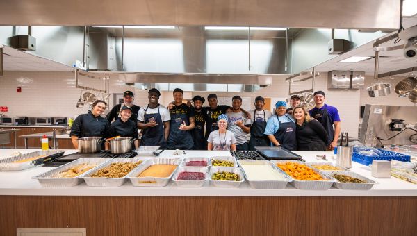 Pictured are those who cooked and baked during last year’s Thanksgiving meal-prep for the residents of Safe Harbor (l to r): Grace McKelvey, Kaelyn Cooper, Justin Grilli, Jude Bourdeau, Wallace King, Sharief Gardiner, Dr. Jeanie Subach (center), Winston Roberts, Nicholas Page, Julian Clement, Regina White, Jessica Chappell, Dominic La Cava, Ethan Small.