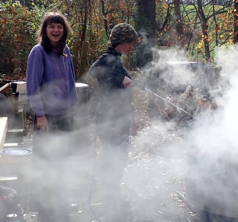 GNA student intern Sophie Dickenson (left) quenching biochar with student intern Mary Teresa O'Hara