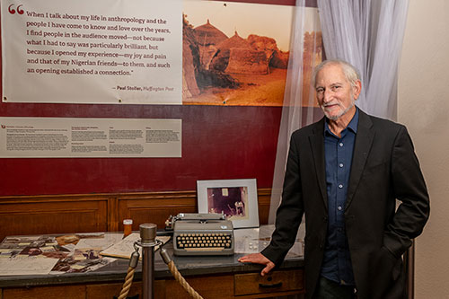 Paul Stoller standing in front of exhibit