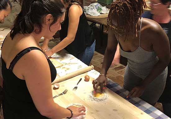 people at a table making food